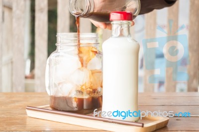 Pouring Espresso To Iced Glass Of Coffee Stock Photo