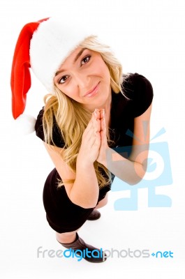 Praying Female Wearing Santa Hat Stock Photo