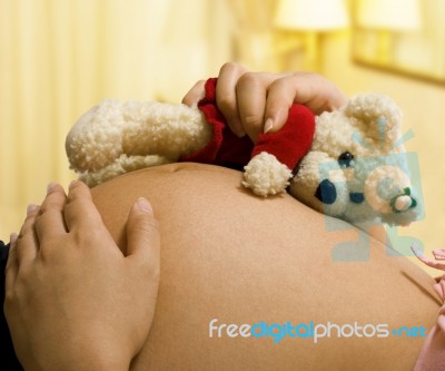 Pregnant Mother Holding Teddy Bear Stock Photo