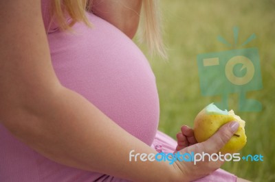 Pregnant Woman Holding Apple Stock Photo