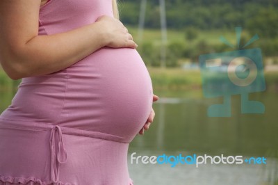Pregnant Woman Holding Belly Stock Photo