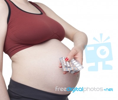Pregnant Woman Holding Pills Stock Photo