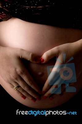 Pregnant Woman Shows Heart Symbol Stock Photo