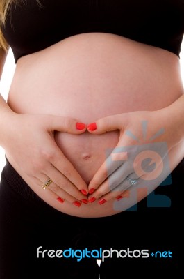 Pregnant Woman Shows Heart Symbol Stock Photo