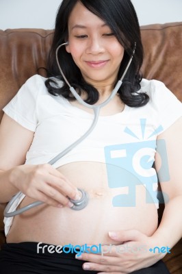 Pregnant Woman Using Stethoscope Stock Photo Pregnant Woman Using Stethoscope Stock Photo