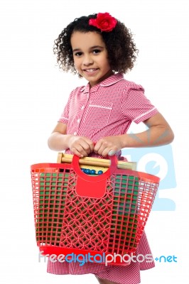 Pretty Child Carrying Math Equipment's In Basket Stock Photo