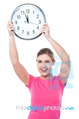 Pretty Girl Holding The Wall Clock Stock Photo