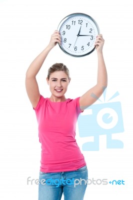 Pretty Girl Holding The Wall Clock Stock Photo