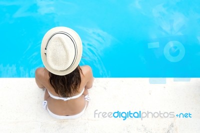 Pretty Girl Relaxing At The Swimming Pool In The Summertime Stock Photo