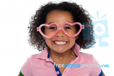 Pretty Girl With A Wide Grin. Wearing Funny Frame Stock Photo