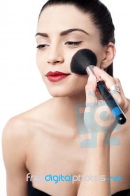 Pretty Woman Applying Makeup With Brush Stock Photo