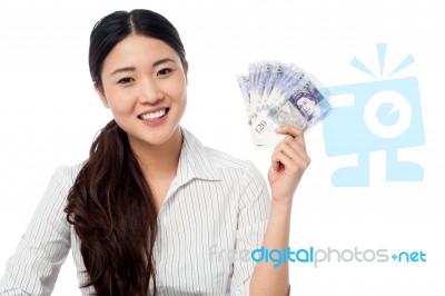 Pretty Woman Holding A Fan Of Currency Notes Stock Photo
