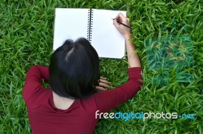 Pretty Women Writing Book Stock Photo