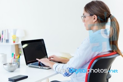 Pretty Young Woman Using Her Laptop In The Office Stock Photo