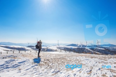 Professional Photographer Takes Photos With Camera In Winter Landscape Stock Photo