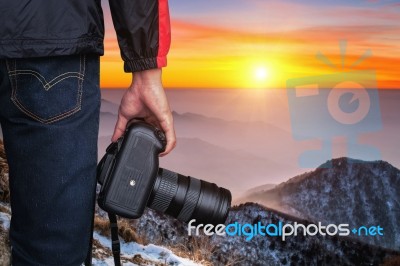 Professional Photographer With Camera At Sunset Stock Photo