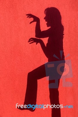 Profile Shadow Of Woman On Red Wall Stock Photo