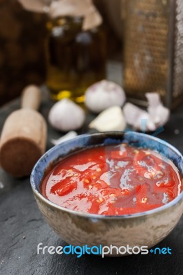 Pureed Tomatoes In A Ceramic Dish On A Table Stock Photo