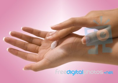 Putting Hand Cream On Her Hands Stock Photo