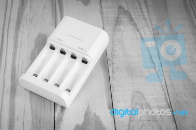 Quick Battery Charger Unit For Charger On Wooden Stock Photo