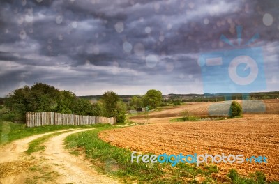 Rain. Spring Storm Clouds Above Country Road Stock Photo