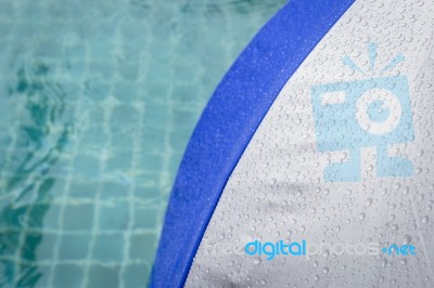 Rain Water Drop On Blue And Grey Umbrella At Poolside Stock Photo