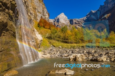 Rainbow In A Waterfall In The Mountains Stock Photo