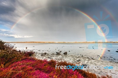 Rainbow In Lake Stock Photo