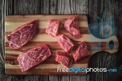 Raw Angus Beef Slices On The Wooden Board Top View Stock Photo
