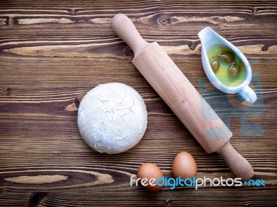 Raw Pizza Dough And Rolling Pin On Wooden Background Stock Photo