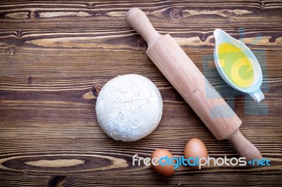 Raw Pizza Dough And Rolling Pin On Wooden Background Stock Photo