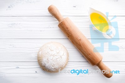 Raw Pizza Dough And Rolling Pin On Wooden Background Stock Photo