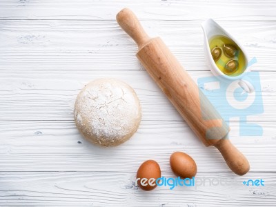 Raw Pizza Dough And Rolling Pin On Wooden Background Stock Photo