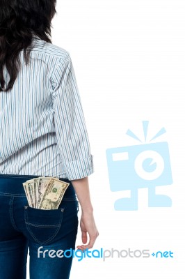 Rear View Of A Girl With Dollars In Her Back Pocket Stock Photo