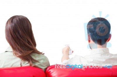 Rear View Of Young Couple Watching Tv On Sofa Stock Photo