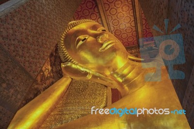 Reclining Buddha Gold Statue Face Stock Photo