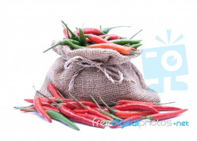 Red And Gren Chilli And Brown Bag With White Background  Stock Photo
