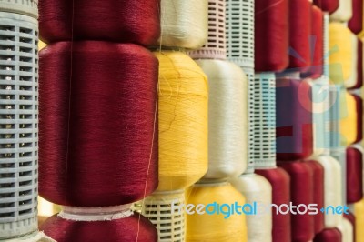 Red And Yellow Silk Thread In Spool Stock Photo