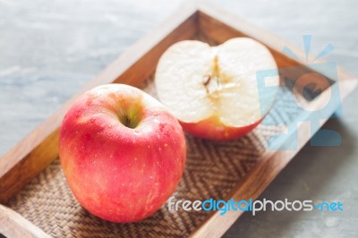 Red Apple On Wooden Tray Stock Photo