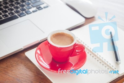 Red Coffee Cup With Notepad And Laptop Stock Photo