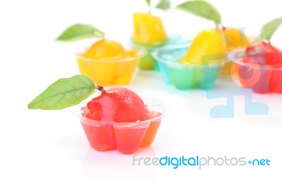 Red Deletable Imitation Fruits In Jelly Cup On White Floor Stock Photo