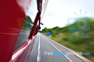 Red Old Bus Going Fast On The Highway Stock Photo