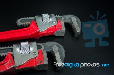 Red Pipe Wrench On Black  Background Stock Photo