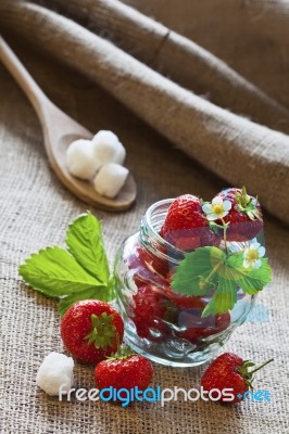 Red Strawberries In Glass Jar Stock Photo