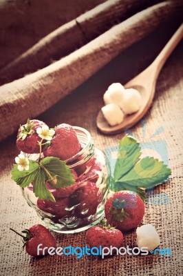 Red Strawberries In Glass Jar On Sackcloth Stock Photo