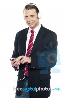 Relaxed Business Executive Tuned Into Music Stock Photo
