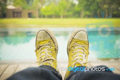 Relaxing By Pool With Dirty Shoes Stock Photo