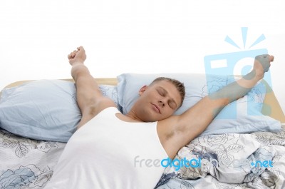 Resting Man Stretching His Arms Stock Photo