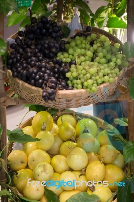 Ripe Grapes And Passion Fruit In The Basket Stock Photo