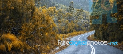 Road And Mountains In The Tasmanian Countryside Stock Photo